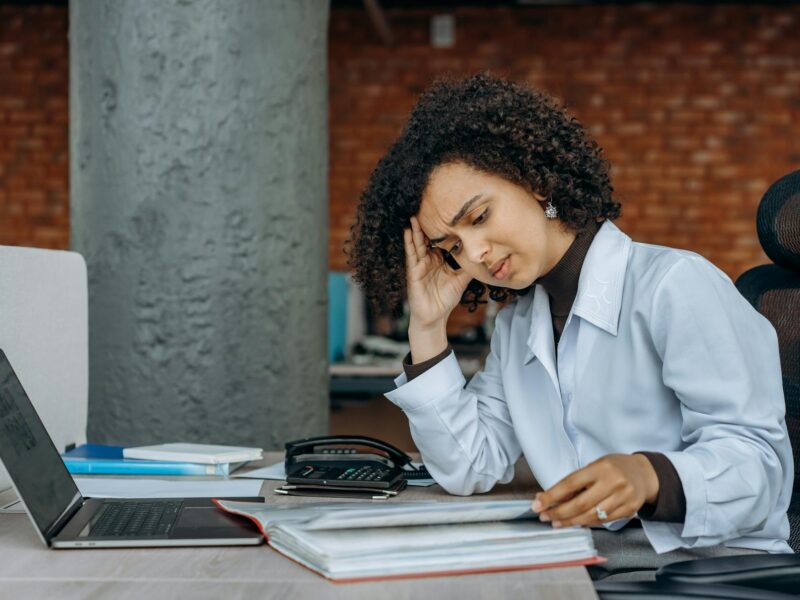 an exhausted woman reading documents